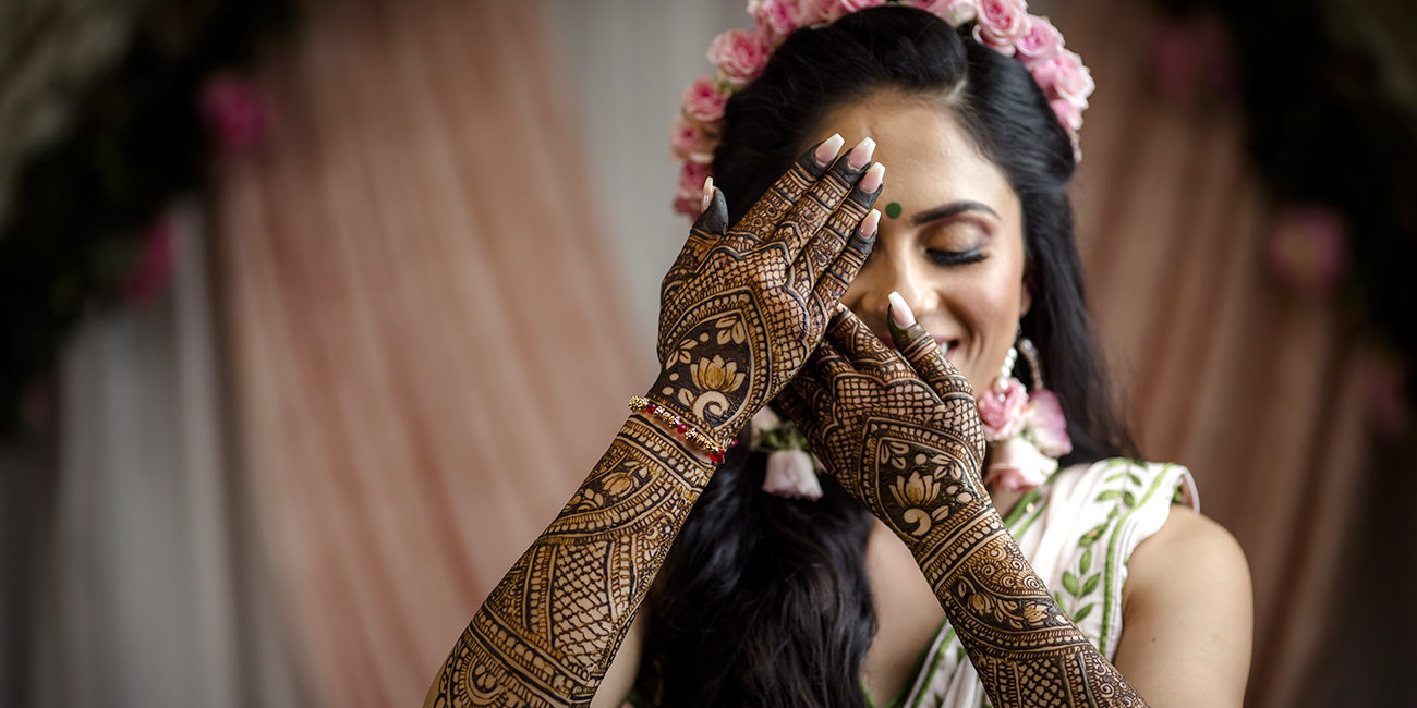 Merge elements of traditional indian henna art with contemporary geometric  shapes. combine a classic paisley motif with geometric patterns to create a  unique fusion design. envision a pose that showcases this cultural